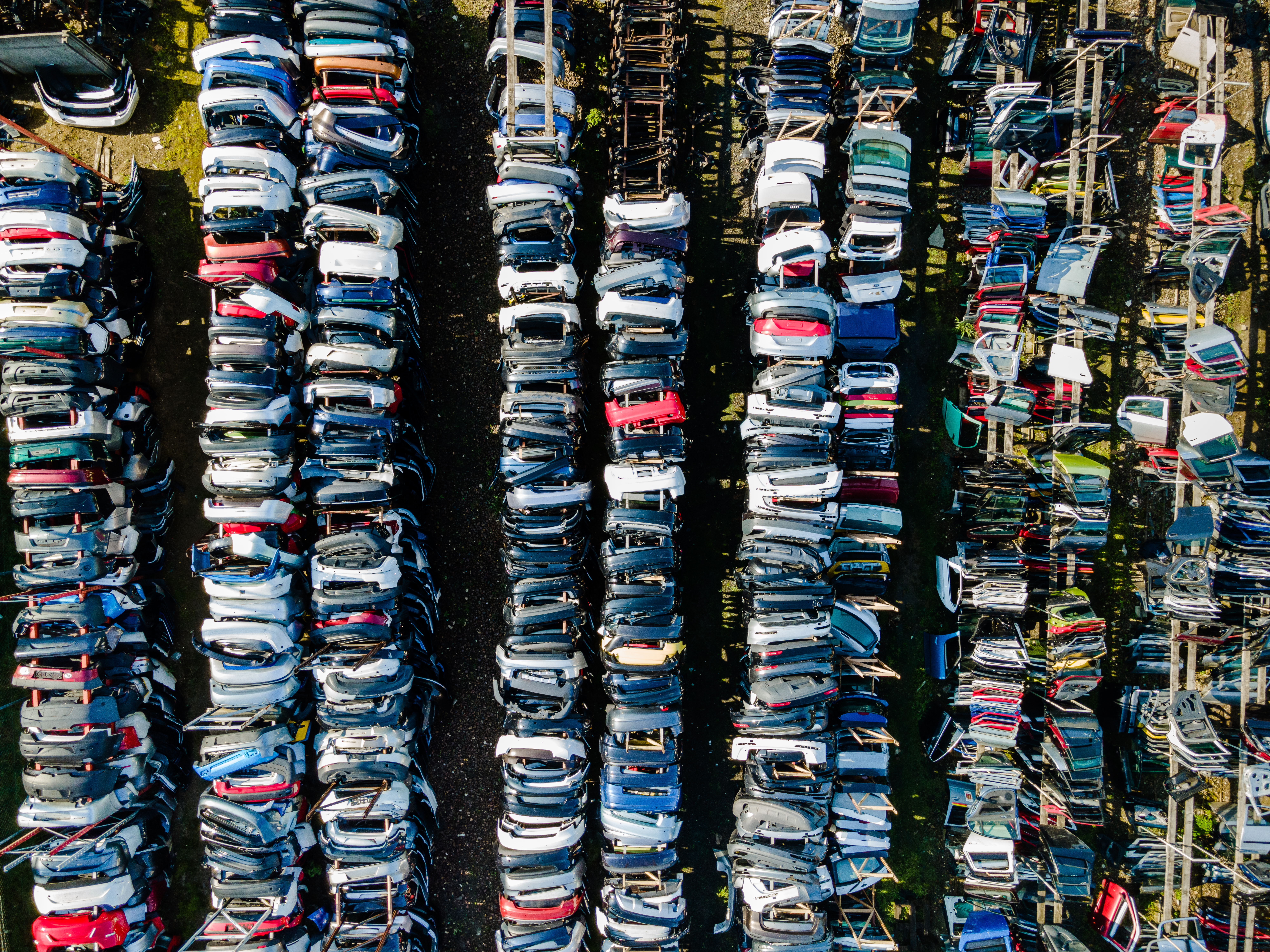 Row of Car Doors in Junkyard. Srap Metal Recycle. Abstract Pattern. Aerial Drone View